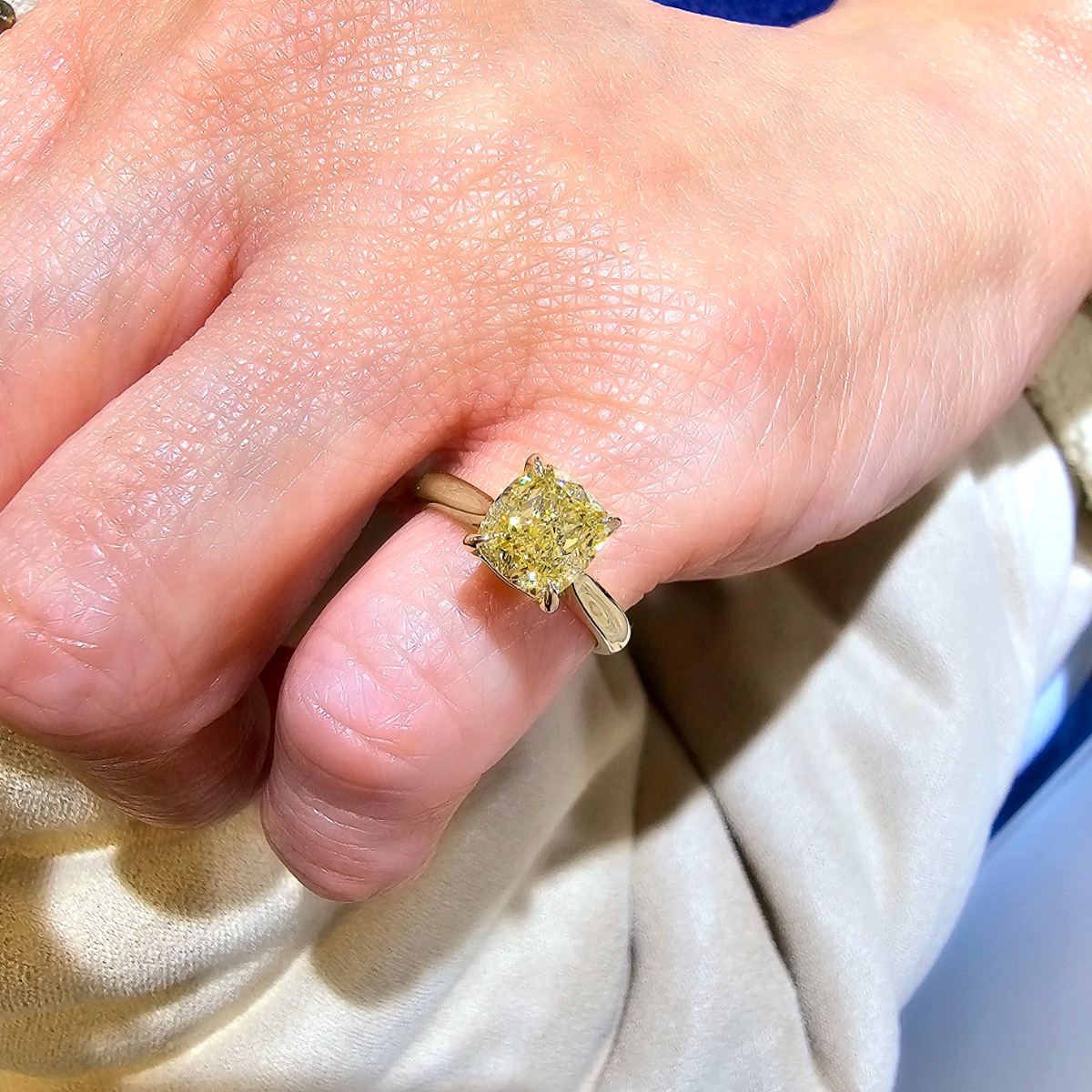 Yellow diamond solitaire on a finger