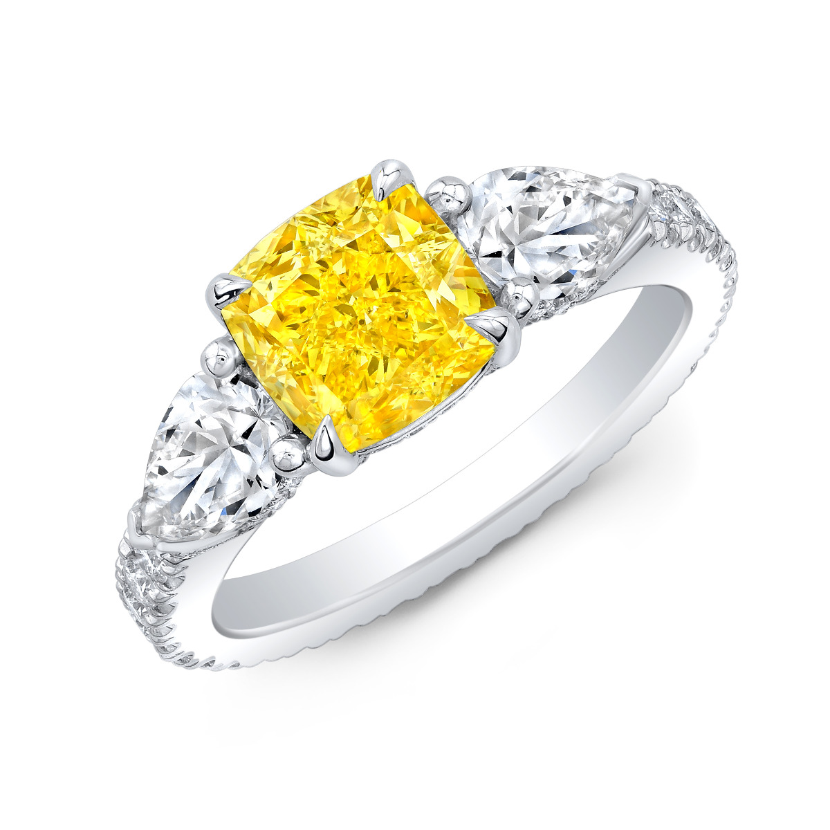 Featuring a Canary Yellow Cushion Cut center stone with beautiful Pear side stones on each side along with a Pave running down the shank.